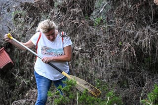 A volunteer looks for missing people, following severe flash flooding that occured during the July 4 holiday weekend, in Hunt, Texas